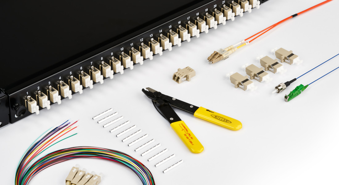 Fiber optic cabling kit with patch panel, fiber optic cables, connectors, stripping tool and adapters.